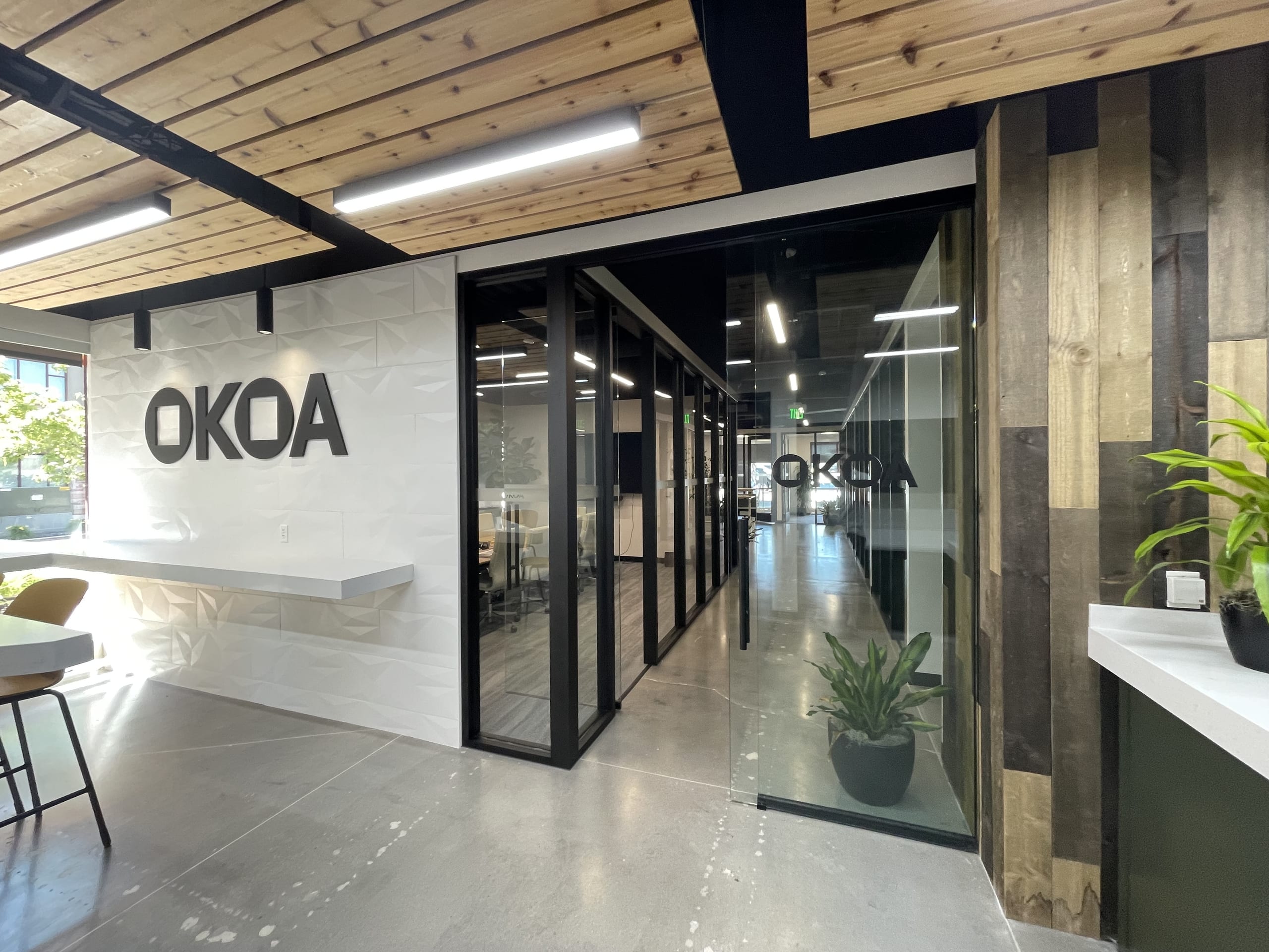 The OKOA office in Park City, with the OKOA sign on the reception wall and offices behind glass